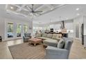 Open-concept living room featuring elegant coffered ceilings, stylish furniture, and seamless access to the gourmet kitchen at 8418 Cape Dutch Loop, Myrtle Beach, SC 29572