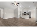 Open concept living space featuring hardwood floors, vaulted ceiling, ceiling fan and modern kitchen at 875 Owls Nest Dr., Conway, SC 29527