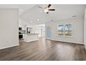 Bright, open-concept living space featuring hardwood floors, a ceiling fan, and modern kitchen with stainless appliances at 875 Owls Nest Dr., Conway, SC 29527