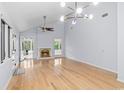 Bright living room with vaulted ceiling, fireplace, modern lighting, and gleaming hardwood floors at 915 Cedarwood Circle, Myrtle Beach, SC 29572