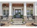 Inviting front porch with stone accents, elegant lighting, and stylish double doors at 1006 Surf Pointe Dr., North Myrtle Beach, SC 29582
