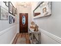 Inviting entryway featuring decor table with mirror, decorative lighting and wood-look flooring at 101 Maddington Place Dr. # 103, Surfside Beach, SC 29575