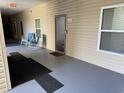 Apartment exterior featuring chairs, door, windows, and a stairway at 101 Maddington Place Dr. # 103, Surfside Beach, SC 29575