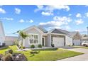 Attractive single-story home featuring stone accents, a well-kept lawn, and an attached one-car garage at 1239 Pyxie Moss Dr., Little River, SC 29566