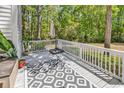 Private deck with white railings, outdoor seating area, umbrella stand and surrounded by lush greenery at 157 Egret Run Ln. # 514, Pawleys Island, SC 29585