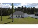 Spacious backyard featuring a small patio area, perfect for outdoor dining and entertaining at 161 Penn Circle, Galivants Ferry, SC 29544