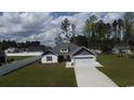 Charming one-story home with a two-car garage, white picket fence, and a well-manicured lawn at 161 Penn Circle, Galivants Ferry, SC 29544