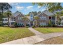 Beautiful two-story condo with well-manicured lawn, brick facade, and inviting walkway at 19 Pistachio Loop # G, Murrells Inlet, SC 29576