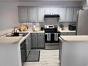 Clean kitchen featuring gray cabinets, stainless steel appliances, and modern countertops at 19 Pistachio Loop # G, Murrells Inlet, SC 29576
