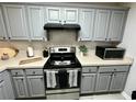 Nicely updated kitchen featuring gray cabinets, stainless steel appliances, and subway tile at 19 Pistachio Loop # G, Murrells Inlet, SC 29576