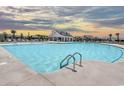Large community pool with lounge chairs and covered outdoor structure at 281 Hawks Run Dr., Calabash, NC 28467