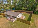 Aerial view of home showcasing fenced yard, private backyard, decks and lush trees at 2939 King St., Loris, SC 29569