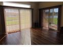 Bright living room with wood floors, large windows, and sliding doors with backyard view at 819 Brookline Dr., Myrtle Beach, SC 29579