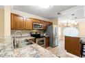 Updated kitchen featuring stainless steel appliances, granite countertops, and wooden cabinets at 820 Fairway Dr. # 1506Hh, Longs, SC 29568