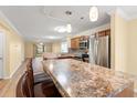 Open-concept kitchen with stainless steel appliances and an island with bar seating at 820 Fairway Dr. # 1506Hh, Longs, SC 29568