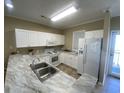Kitchen with white appliances and cabinets at 901-9 West Port Dr. # 907, North Myrtle Beach, SC 29582