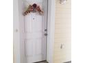Charming front door with floral wreath and house number, complemented by siding and hardware at 1000 Ray Costin Way # 108, Murrells Inlet, SC 29576