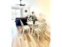 Cozy dining area with a glass table, comfortable chairs, and hardwood floors at 103 Club Circle # 1-1, Pawleys Island, SC 29585