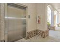 Convenient condo building elevator access with brick and concrete flooring and a fire extinguisher at 1033 World Tour Blvd. # 203, Myrtle Beach, SC 29579