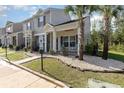 Attractive townhome showcasing professional landscaping, covered porch and convenient accessible parking at 1105 Dinger Ct. # 1105, Myrtle Beach, SC 29588