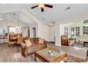 Open-concept living room boasts high ceilings, wood floors, and seamless flow to dining and lounge areas at 145 Stonegate Blvd. # 145, Murrells Inlet, SC 29576