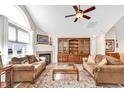 Inviting living room with a fireplace, vaulted ceilings, and a large window for natural light at 145 Stonegate Blvd. # 145, Murrells Inlet, SC 29576