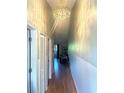 Hallway with a decorative chandelier and doors, creating an inviting ambiance at 1450 Blue Tree Ct. # I, Myrtle Beach, SC 29588