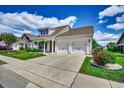 Beautiful home with a two-car garage, well-maintained lawn and vibrant landscaping at 168 Zostera Dr., Little River, SC 29566