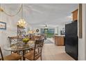 Open-concept living area with dining space, leading to a well-lit living room with a view of the outdoors at 1880 Auburn Ln. # 27 A, Surfside Beach, SC 29575