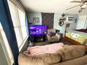 Living room with large window, seating, TV, and view of a bed at 202 28Th Ave. N # 5, North Myrtle Beach, SC 29582