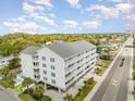 Aerial view of condo complex with palm trees, street, and surrounding neighborhood at 2406 S Ocean Blvd. # 301, North Myrtle Beach, SC 29582