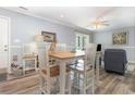 Dining area with wooden table, upholstered chairs, and view into the living room at 2406 S Ocean Blvd. # 301, North Myrtle Beach, SC 29582