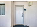 Exterior image of a white apartment door with silver hardware and the unit number, 915, on a blue sign at 2711 Ocean Blvd. S # 915, North Myrtle Beach, SC 29582