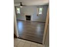 Living room with hardwood floors, a cozy fireplace, neutral paint, and natural light at 302 St. Andrews Ln., Myrtle Beach, SC 29588
