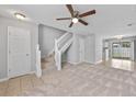 Inviting living room featuring plush carpet, a ceiling fan, and staircase access at 3563 Chestnut Dr. # 3563, Myrtle Beach, SC 29577