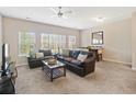 Spacious living room featuring carpet, a ceiling fan and lots of natural light at 3943 Gladiola Ct. # 202, Myrtle Beach, SC 29588