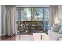 Cozy balcony with seating offers relaxing outdoor space and views at 410 Melrose Pl. # 110, Myrtle Beach, SC 29572