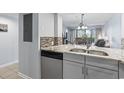 Well-appointed kitchen features stainless steel appliances and stylish mosaic backsplash at 410 Melrose Pl. # 110, Myrtle Beach, SC 29572