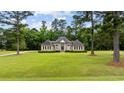 Beautifully landscaped brick home on a large lot with mature trees at 4100 Hagwood Circle, Conway, SC 29526
