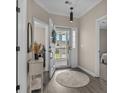 Welcoming entryway boasts wood floors, neutral tones, and floods of natural light from the doorway at 411 Mahogany Dr. # 202, Murrells Inlet, SC 29576
