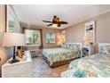 Cozy bedroom featuring two beds, coastal decor, soft lighting, and tiled floors for a comfortable retreat at 4201 N Ocean Blvd. # 2H, North Myrtle Beach, SC 29582