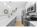 Bright kitchen features updated appliances, grey cabinets, and a pass-through to living area at 4518 N Planatation Harbour Dr. # G-17, Little River, SC 29566