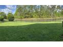 Spacious backyard with a black metal fence surrounding a pond, offering privacy and serene views at 505 Heartland Ct., Murrells Inlet, SC 29576