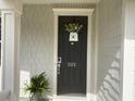 Close-up view of a stylish black front door adorned with a decorative wreath and house number at 505 Heartland Ct., Murrells Inlet, SC 29576