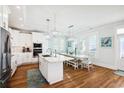 Bright kitchen with an island, stainless steel appliances, white cabinets, pendant lighting, and an adjacent dining area at 5203 N Ocean Blvd. N, North Myrtle Beach, SC 29582