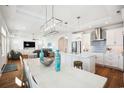 Open-concept living area featuring a kitchen, dining table, and living room with modern lighting and hardwood floors at 5203 N Ocean Blvd. N, North Myrtle Beach, SC 29582