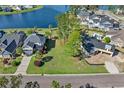 Aerial view of the vacant lot with nearby lake in a neighborhood with mature trees and manicured lawns at 573 Starlit Way, Myrtle Beach, SC 29579