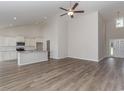 Bright open-concept living area with high ceilings, modern flooring and a view into the kitchen at 625 Woodside Dr., Conway, SC 29526