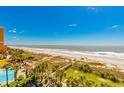 Stunning aerial view of beach and pool area with palm trees at 6804 N Ocean Blvd. # 523, Myrtle Beach, SC 29572