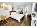 Cozy bedroom with a queen bed, wood floors, and modern decor at 6900 N Ocean Blvd. # 1034, Myrtle Beach, SC 29579